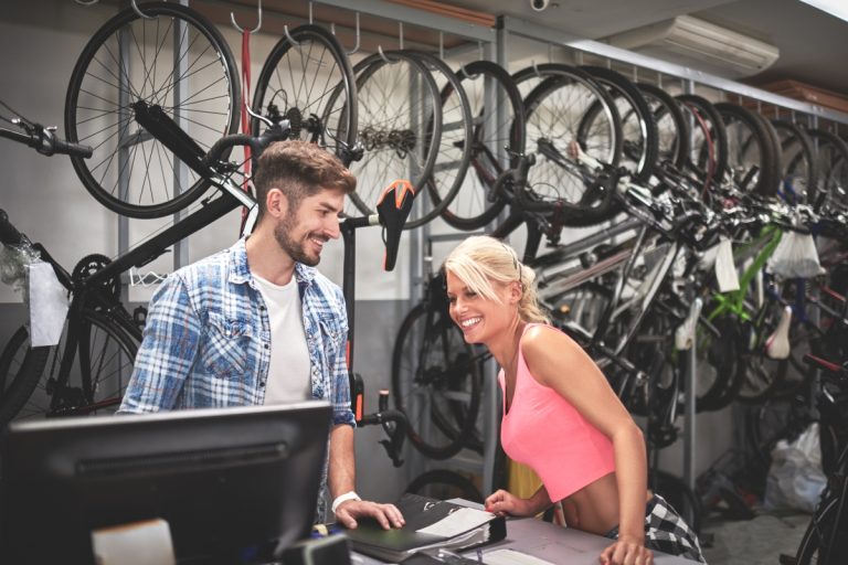 Heavy industrial machine parts: yellow hydraulic components and black sprockets.